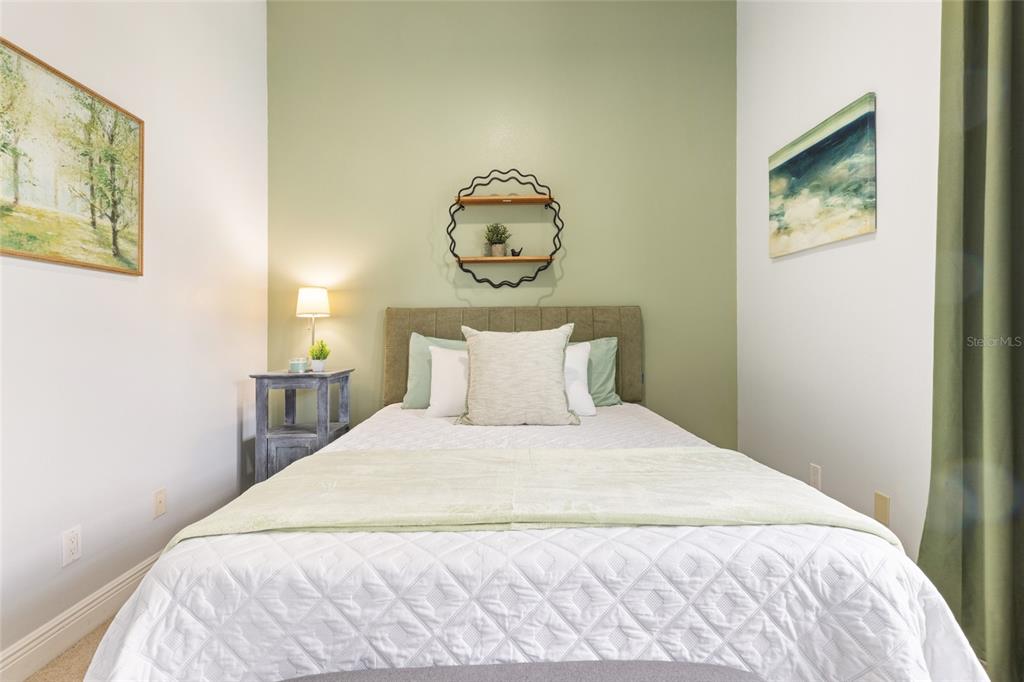 141 175th Avenue East Redington Shores, FL 33708 - Photo 21 of 51 a large bed in a bedroom next to a window