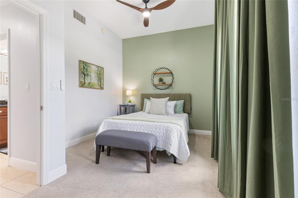 141 175th Avenue East Redington Shores, FL 33708 - Photo 22 of 51 a bedroom with a bed and a wall painting