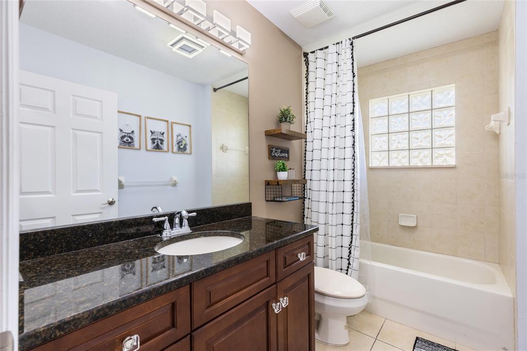 141 175th Avenue East Redington Shores, FL 33708 - Photo 24 of 51 a bathroom with a granite countertop sink toilet and shower