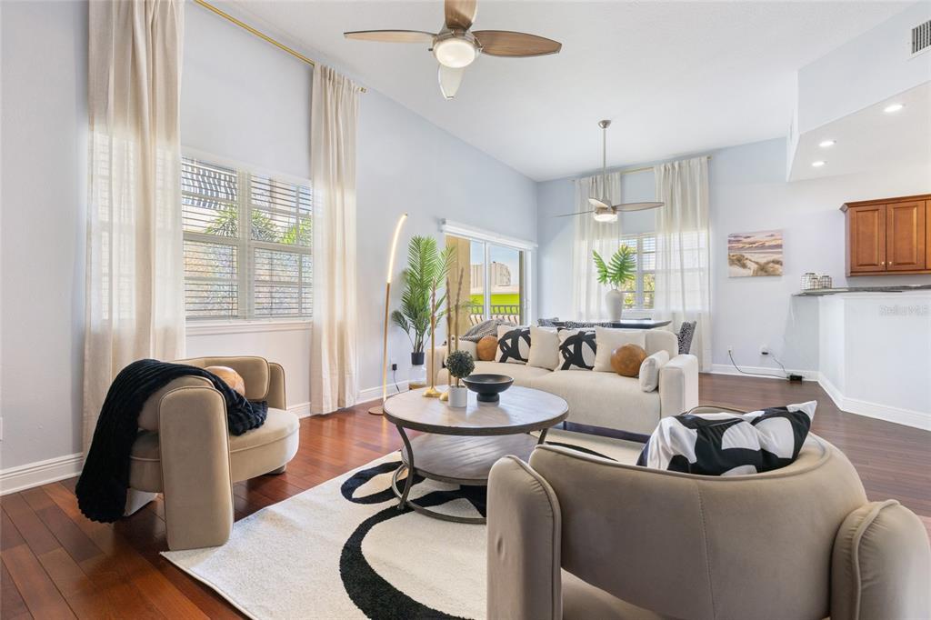 141 175th Avenue East Redington Shores, FL 33708 - Photo 3 of 51 a living room with furniture a window and a chandelier