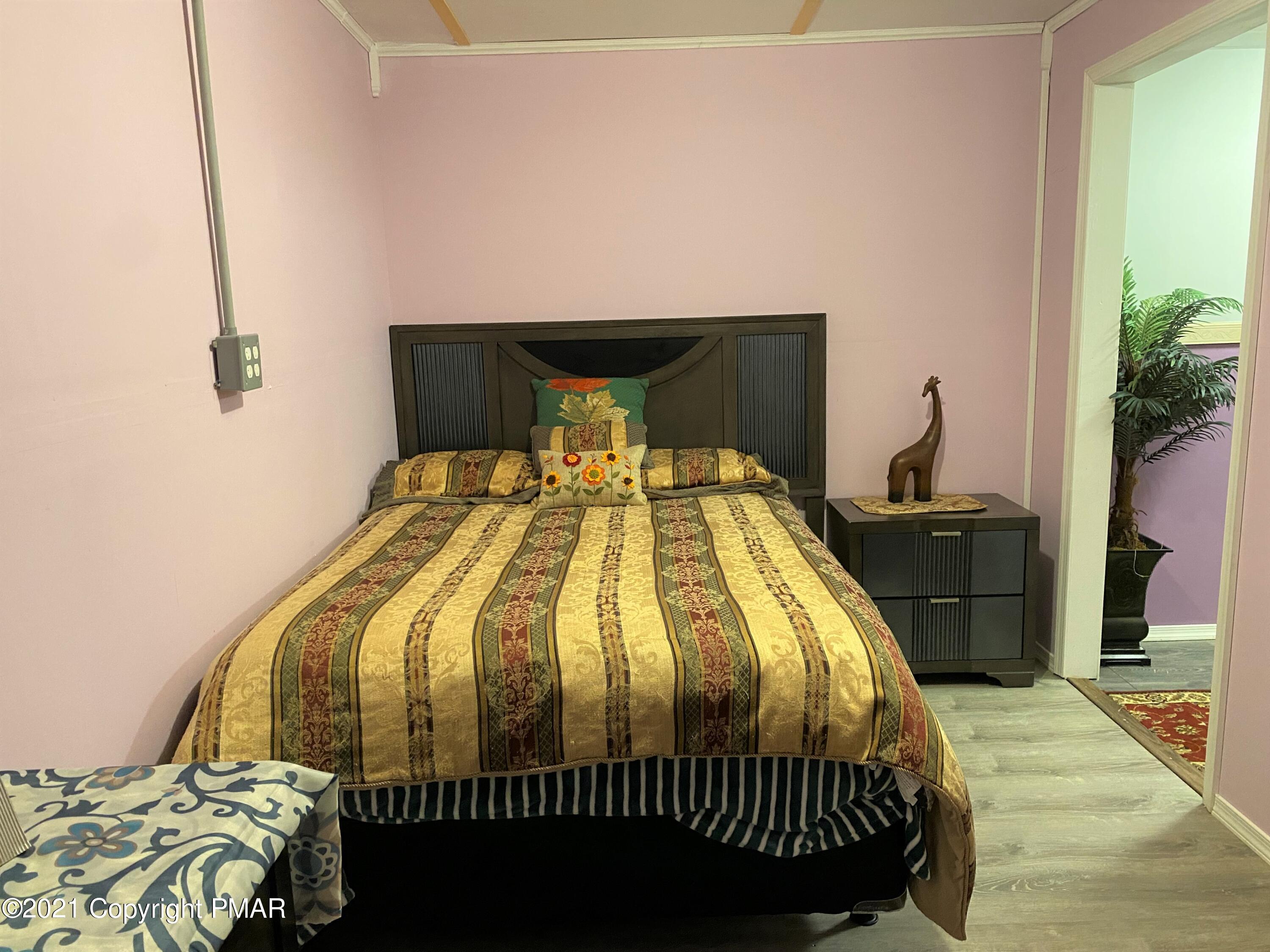 341 Chestnut Road Blakeslee, PA 18610 - Photo 24 of 30 a bed sitting in a bedroom next to a window