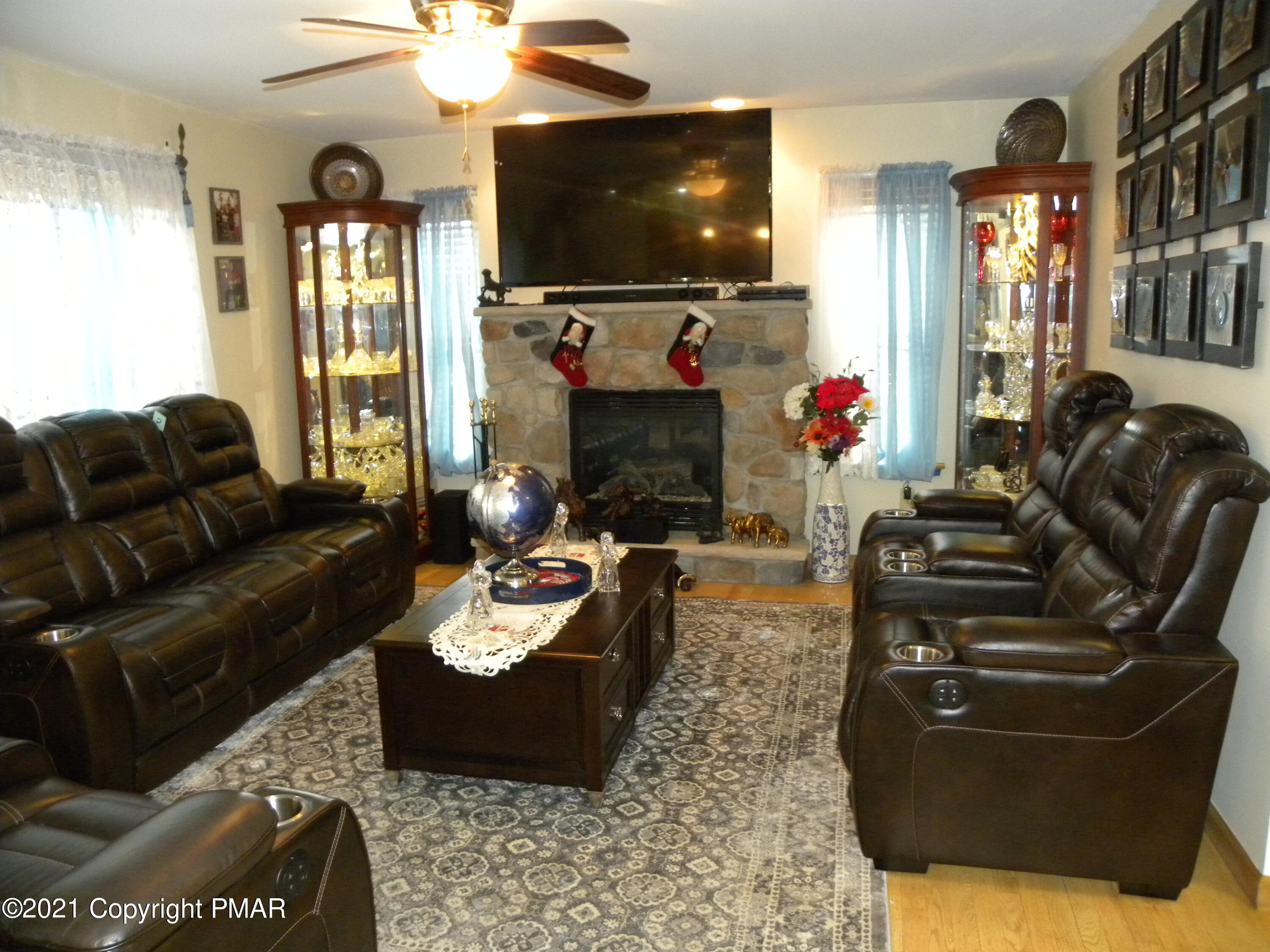 341 Chestnut Road Blakeslee, PA 18610 - Photo 3 of 30 a living room with furniture a flat screen tv and a fireplace