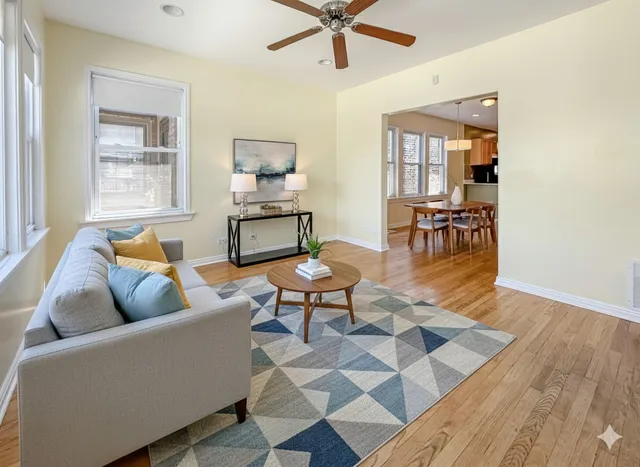 a living room with furniture and a wooden floor