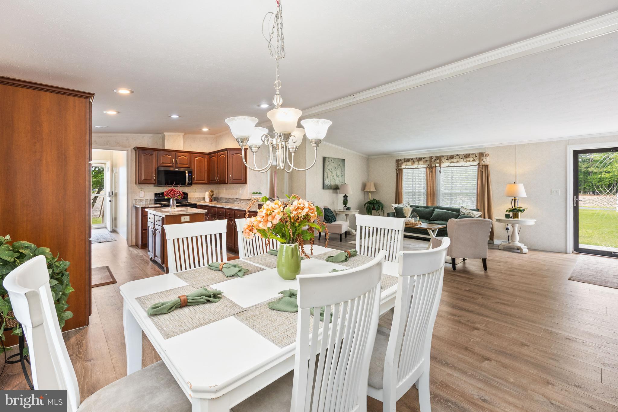 4258 Smith Road Salisbury, MD 21801 - Photo 18 of 43 a view of a dining room and livingroom view with furniture wooden floor a chandelier
