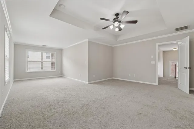 a view of an empty room with a ceiling fan