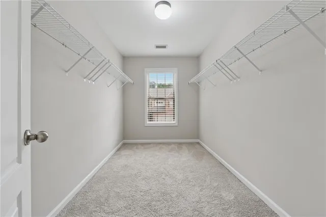 a view of a small space with wooden floor and a window
