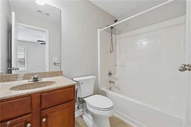 a bathroom with a sink toilet vanity and shower