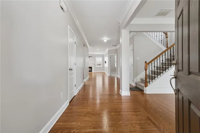 a view of entryway and hall with wooden floor