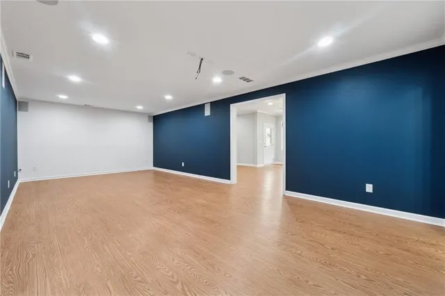a view of an empty room with wooden floor