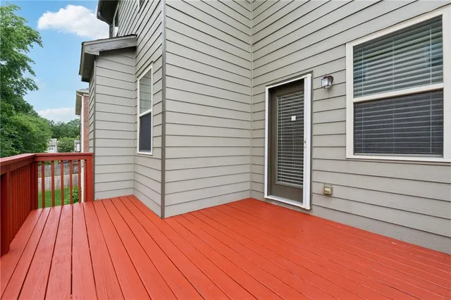 a view of backyard with a deck and wooden floor