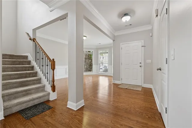 a view of entryway with wooden floor and stairs