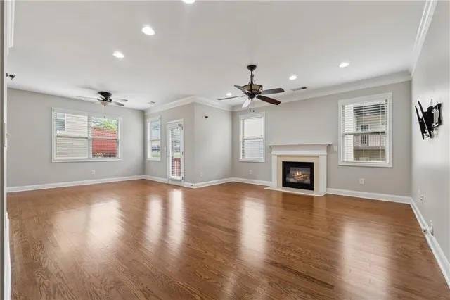 a view of an empty room with a fireplace and a window