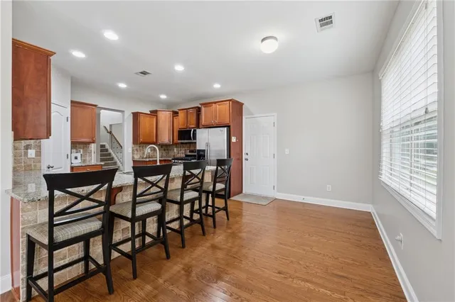 a view of a dining room with furniture and wooden floor