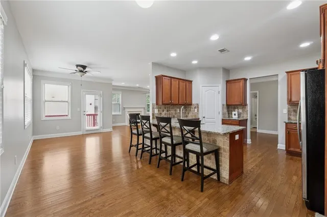 a view of a a dining room with furniture window and wooden floor
