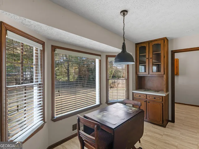 a living room with furniture a flat screen tv and a floor to ceiling window