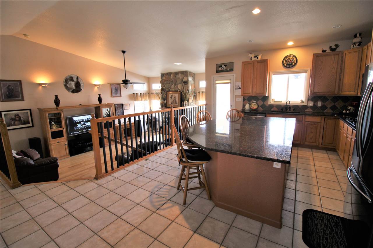 3455 F Road Clifton, CO 81520 - Photo 8 of 29 a kitchen with stainless steel appliances kitchen island granite countertop a sink and cabinets