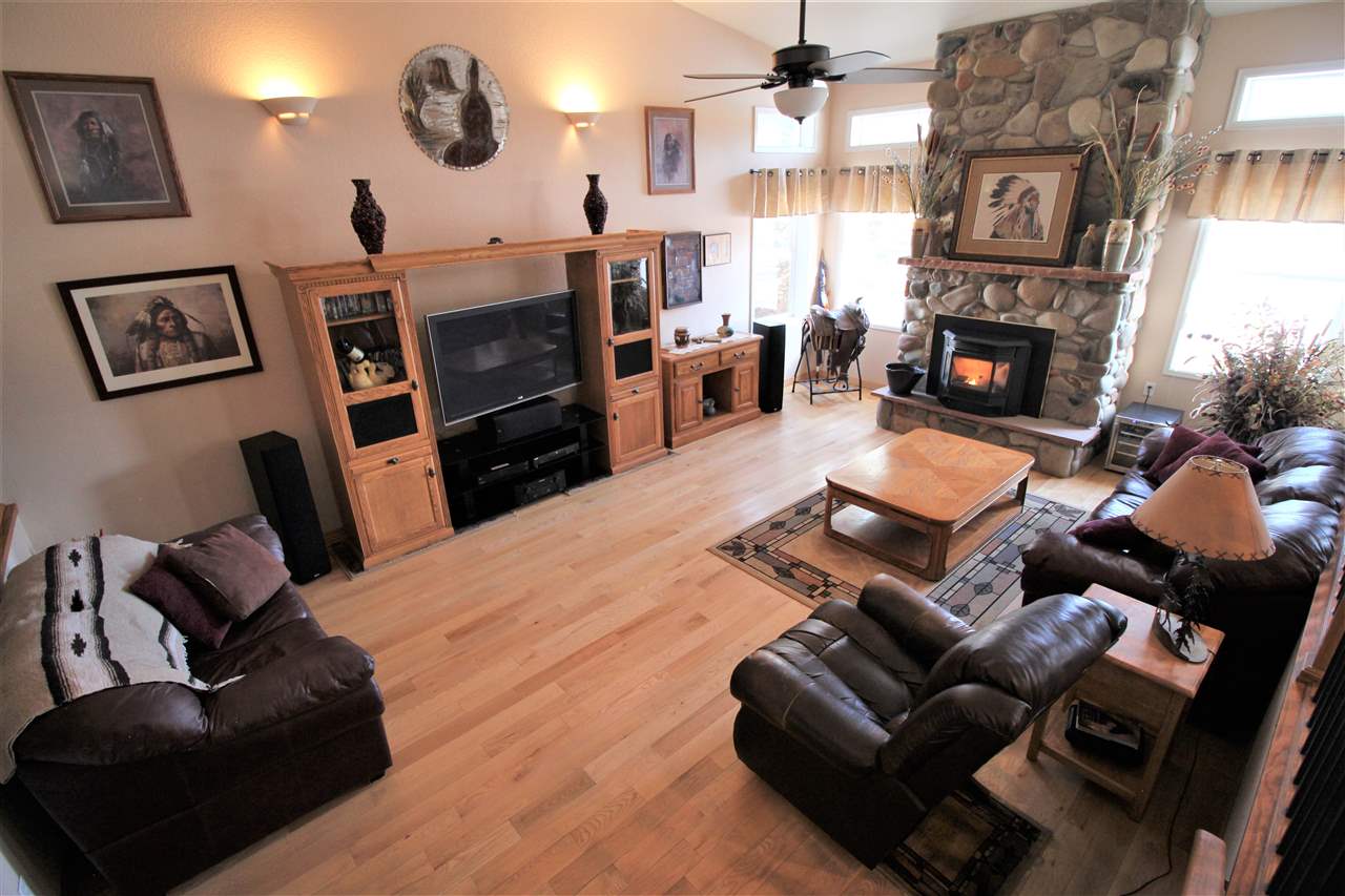 3455 F Road Clifton, CO 81520 - Photo 9 of 29 a living room with furniture a fireplace and a large mirror