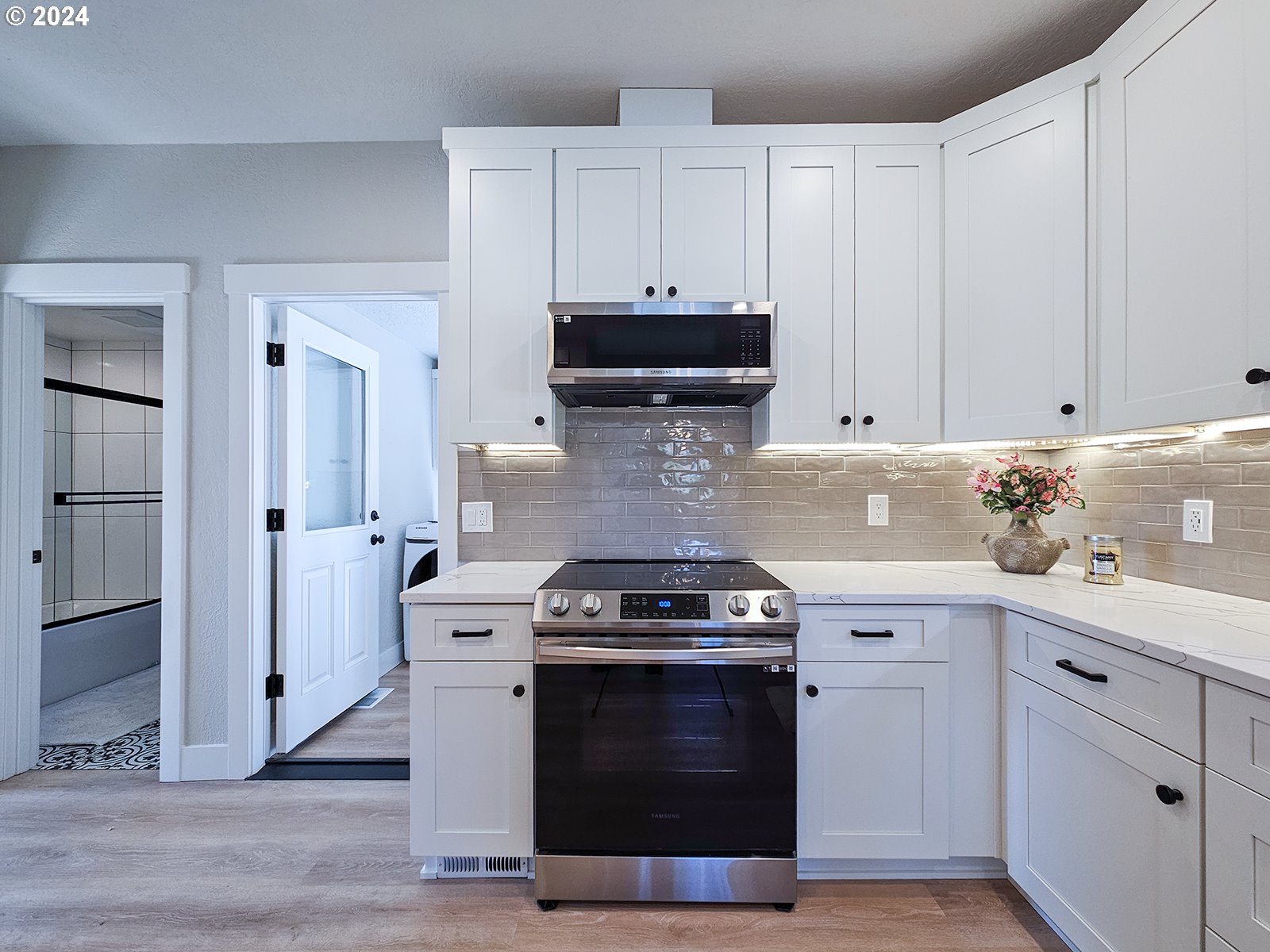 1532 Northeast Morgan Street Portland, OR 97211 - Photo 13 of 35 a kitchen with white cabinets and appliances