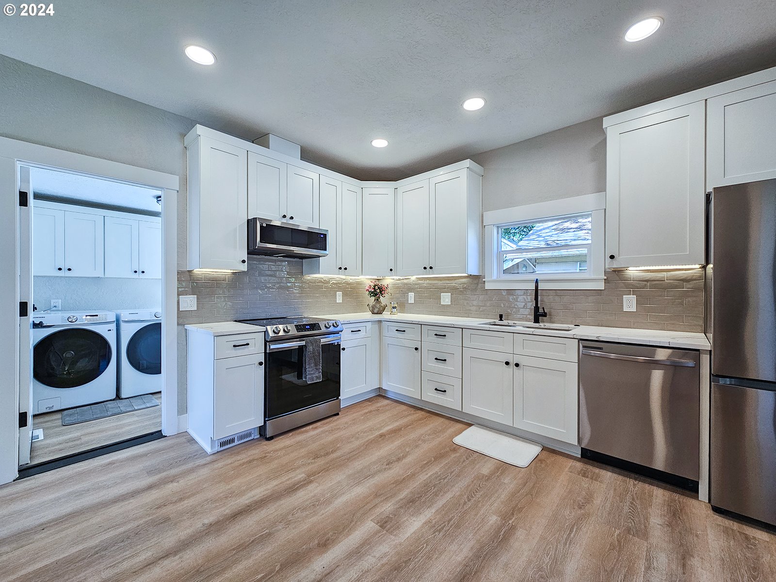 1532 Northeast Morgan Street Portland, OR 97211 - Photo 15 of 35 a kitchen with stainless steel appliances granite countertop a stove a sink and a refrigerator