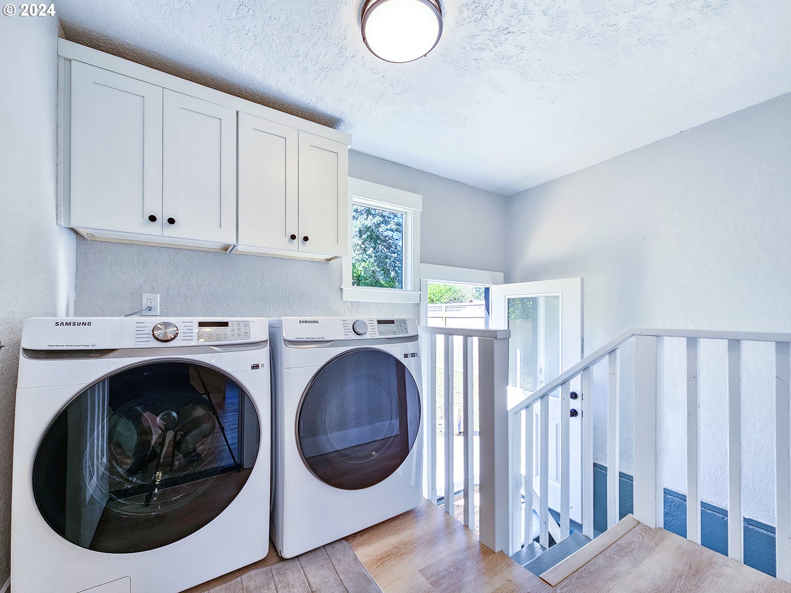 1532 Northeast Morgan Street Portland, OR 97211 - Photo 18 of 35 a view of a hallway with washer and dryer