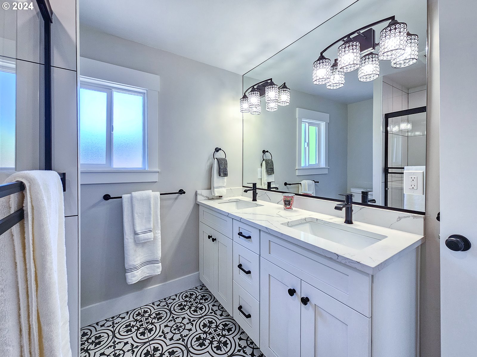1532 Northeast Morgan Street Portland, OR 97211 - Photo 21 of 35 a spacious bathroom with a double vanity sink a mirror and a shower