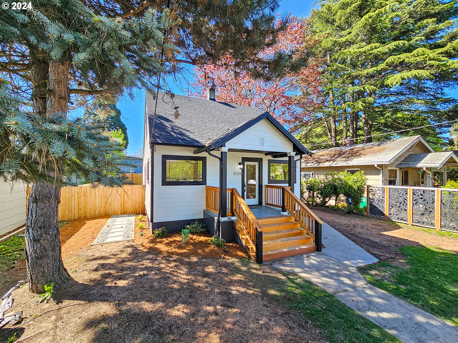 1532 Northeast Morgan Street Portland, OR 97211 - Photo 3 of 35 a front view of a house with a yard