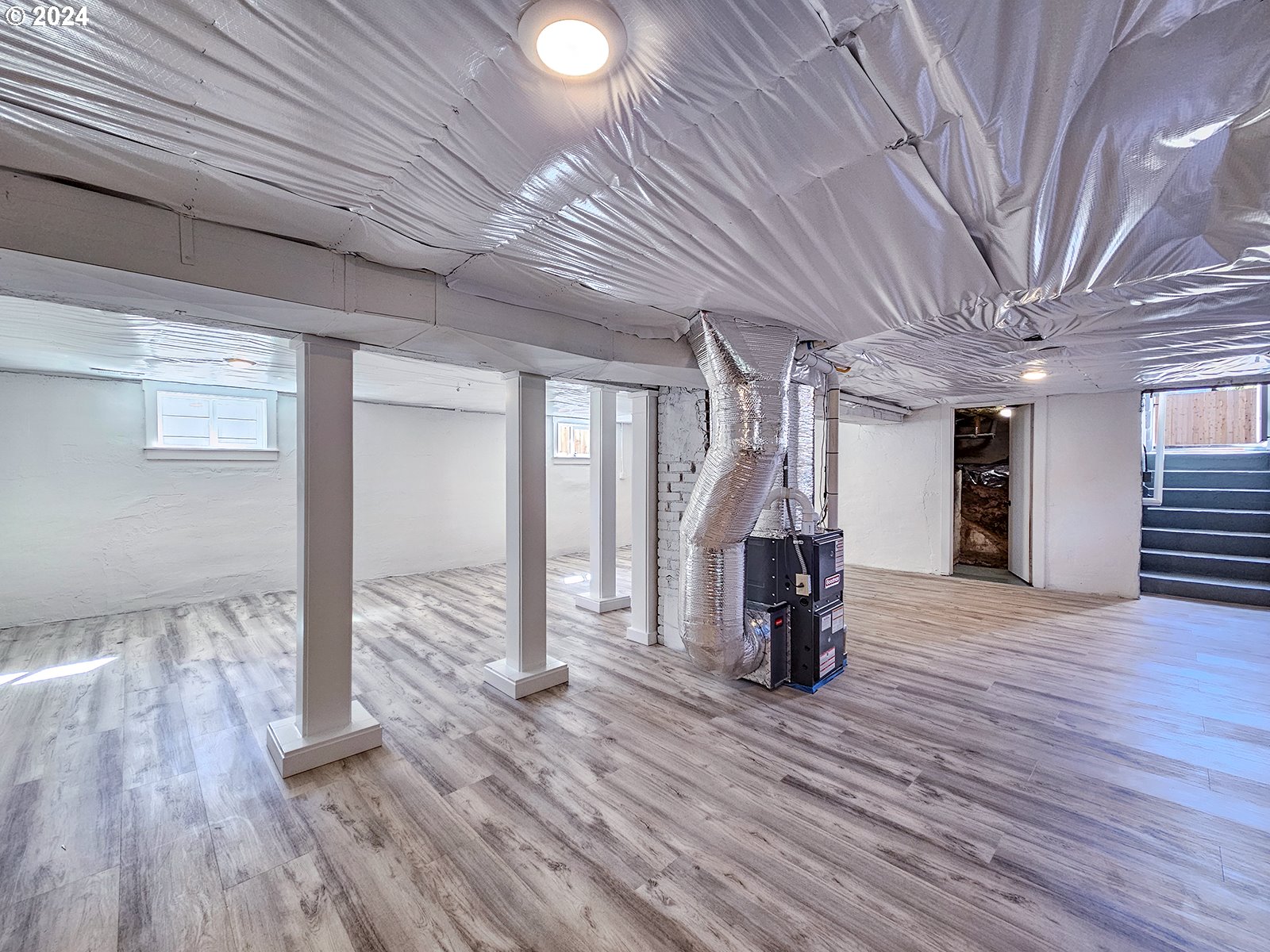 1532 Northeast Morgan Street Portland, OR 97211 - Photo 31 of 35 a view of livingroom with wooden floor and stairs