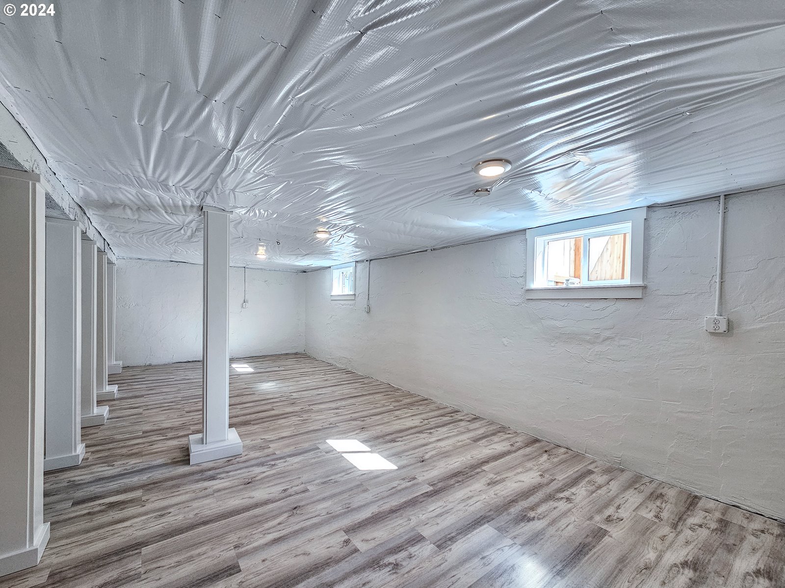 1532 Northeast Morgan Street Portland, OR 97211 - Photo 32 of 35 a view of an empty room with wooden floor and a window