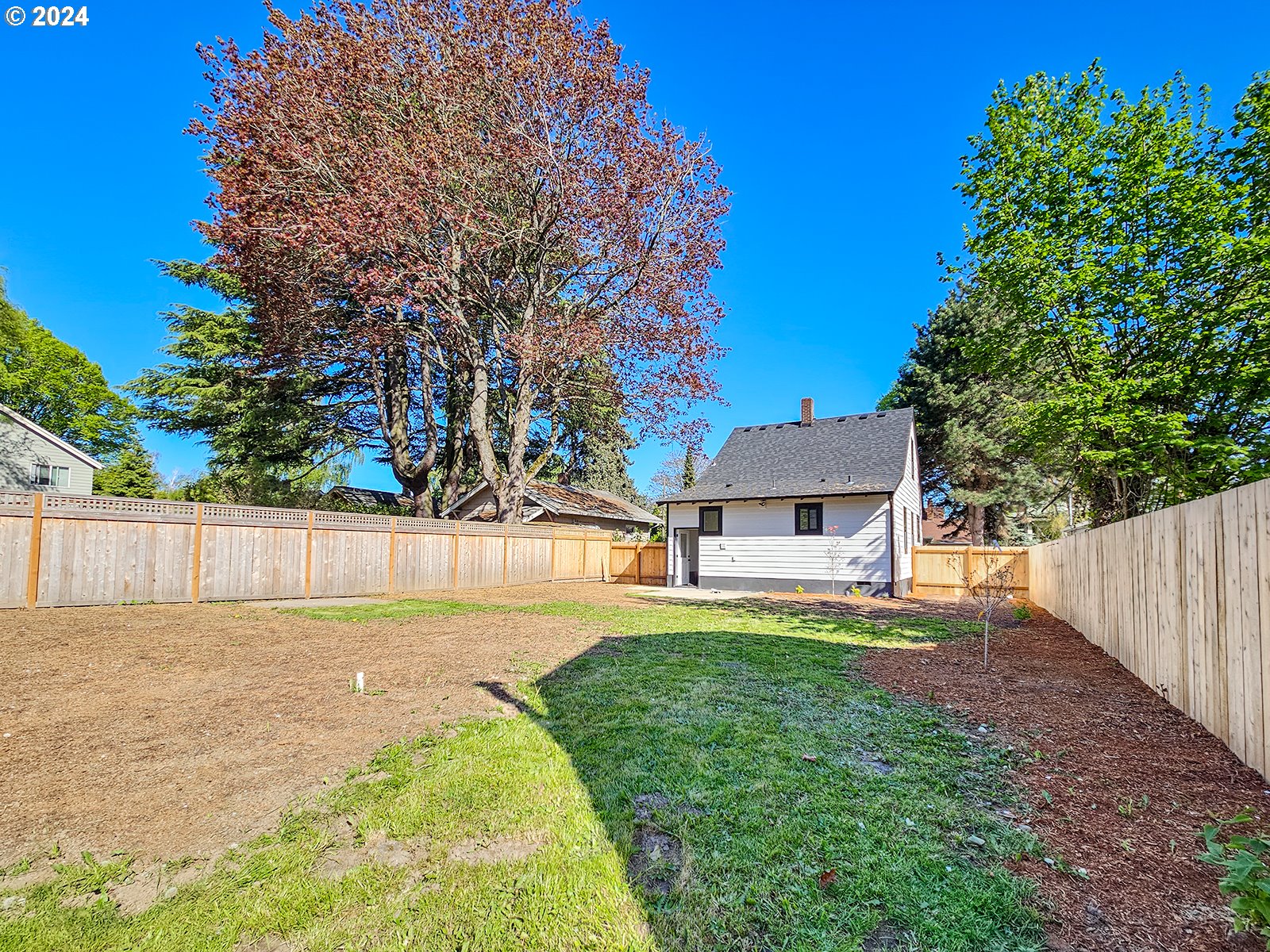 1532 Northeast Morgan Street Portland, OR 97211 - Photo 34 of 35 a view of a house with a yard and a large tree