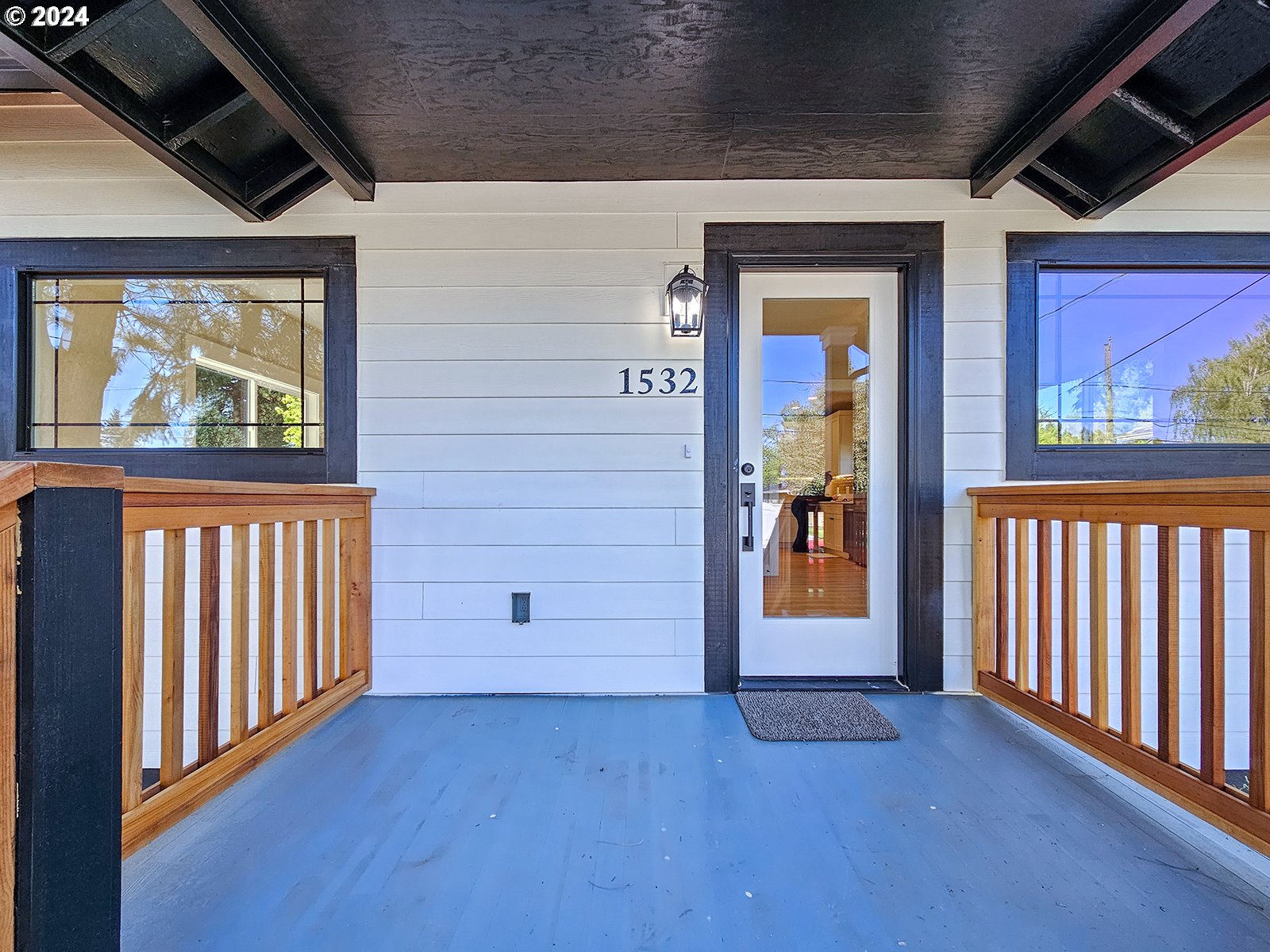 1532 Northeast Morgan Street Portland, OR 97211 - Photo 4 of 35 a view of a hallway with wooden floor and windows