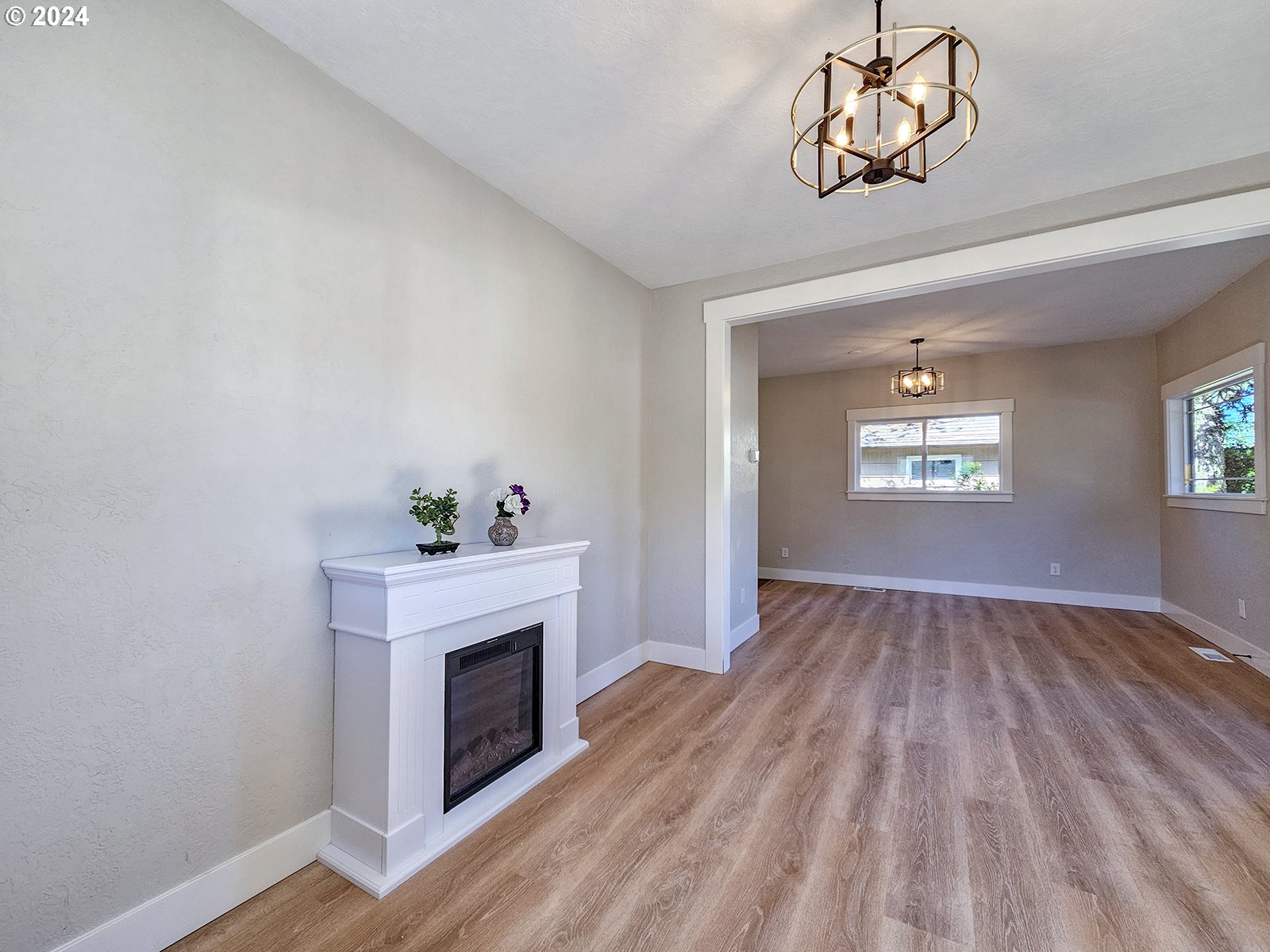 1532 Northeast Morgan Street Portland, OR 97211 - Photo 7 of 35 a view of an empty room with wooden floor fireplace and a window