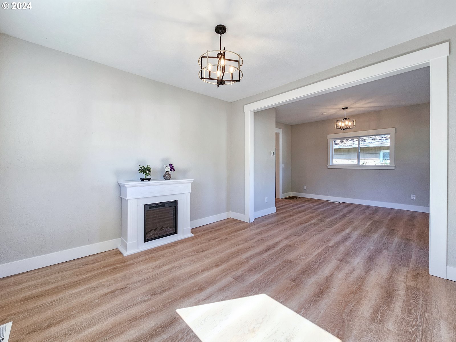 1532 Northeast Morgan Street Portland, OR 97211 - Photo 8 of 35 a view of an empty room with a fireplace and a window