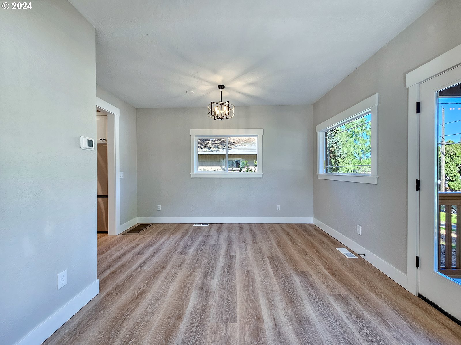 1532 Northeast Morgan Street Portland, OR 97211 - Photo 10 of 35 wooden floor in an empty room with a window