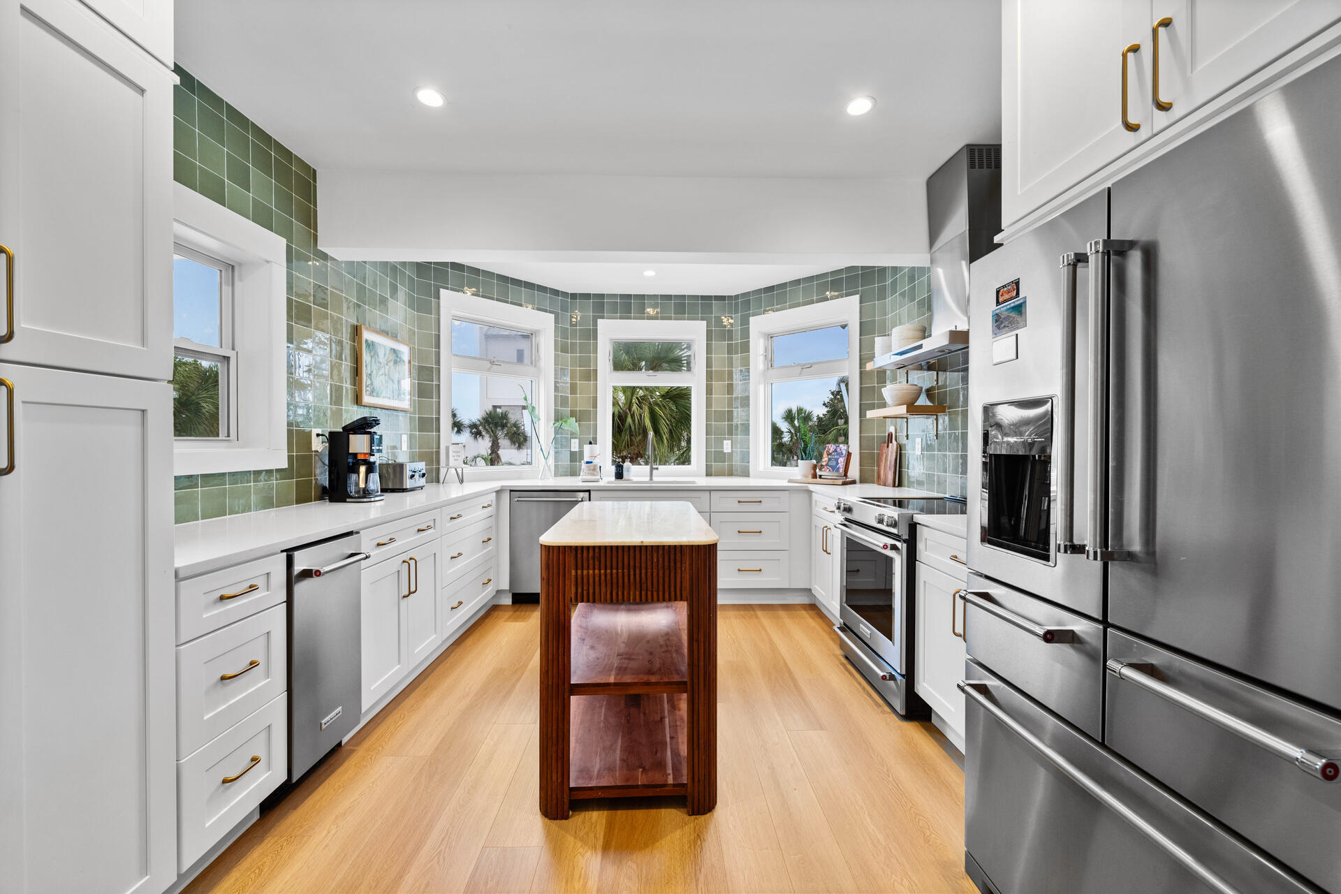 169 Pompano Street Inlet Beach, FL 32461 - Photo 20 of 91 a kitchen with stainless steel appliances a refrigerator a stove and white cabinets with wooden floor