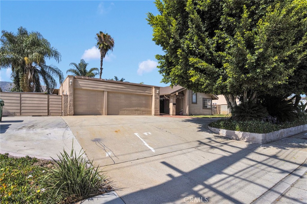 1087 Baseline Road La Verne, CA 91750 - Photo 2 of 39 a view of a white house with a yard and potted plants