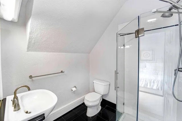 a bathroom with a toilet a sink and a shower