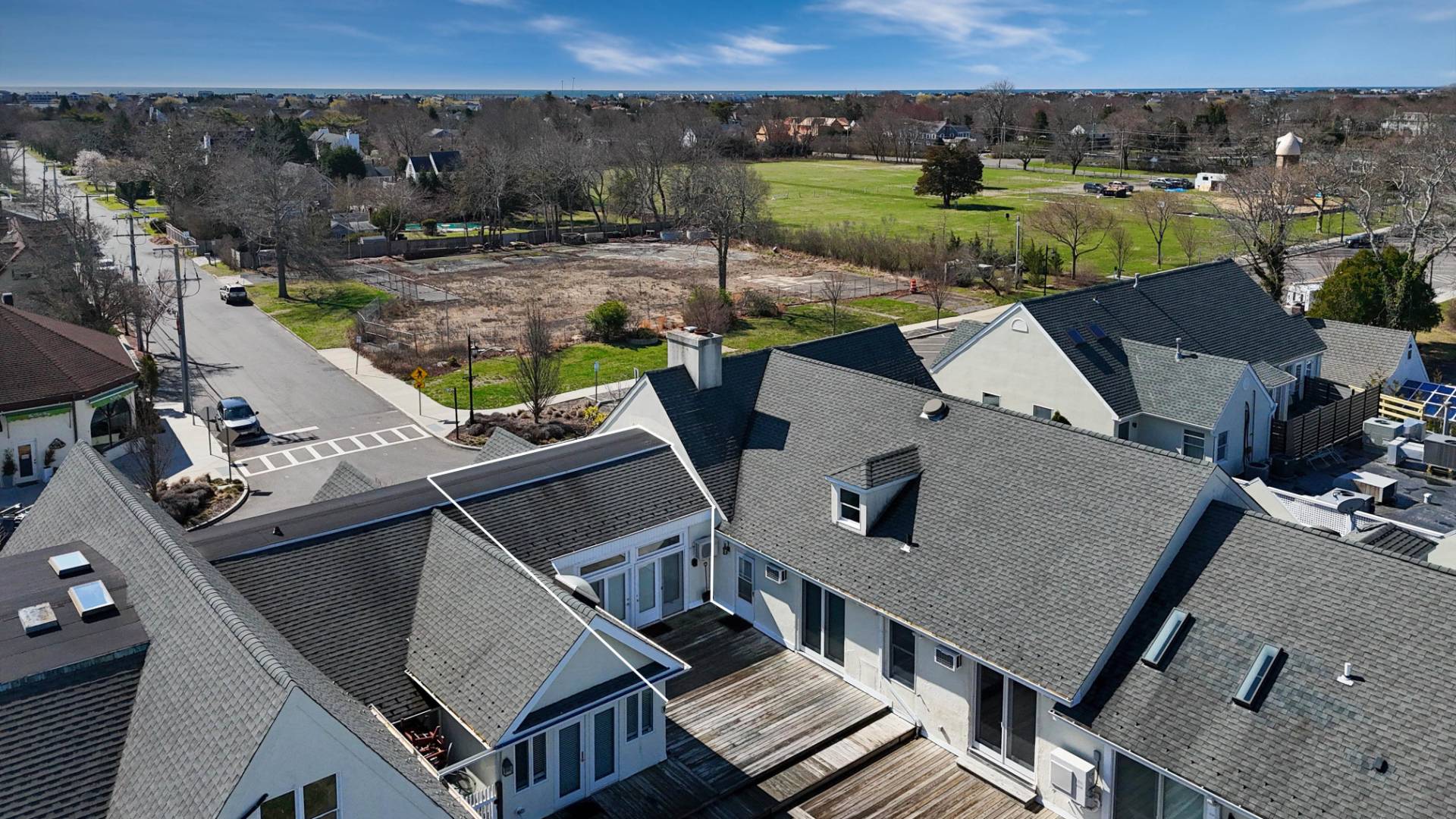 52 Main Street, Unit 1 Westhampton Beach, NY 11978 - Photo 13 of 13 an aerial view of a house with garden space and outdoor seating