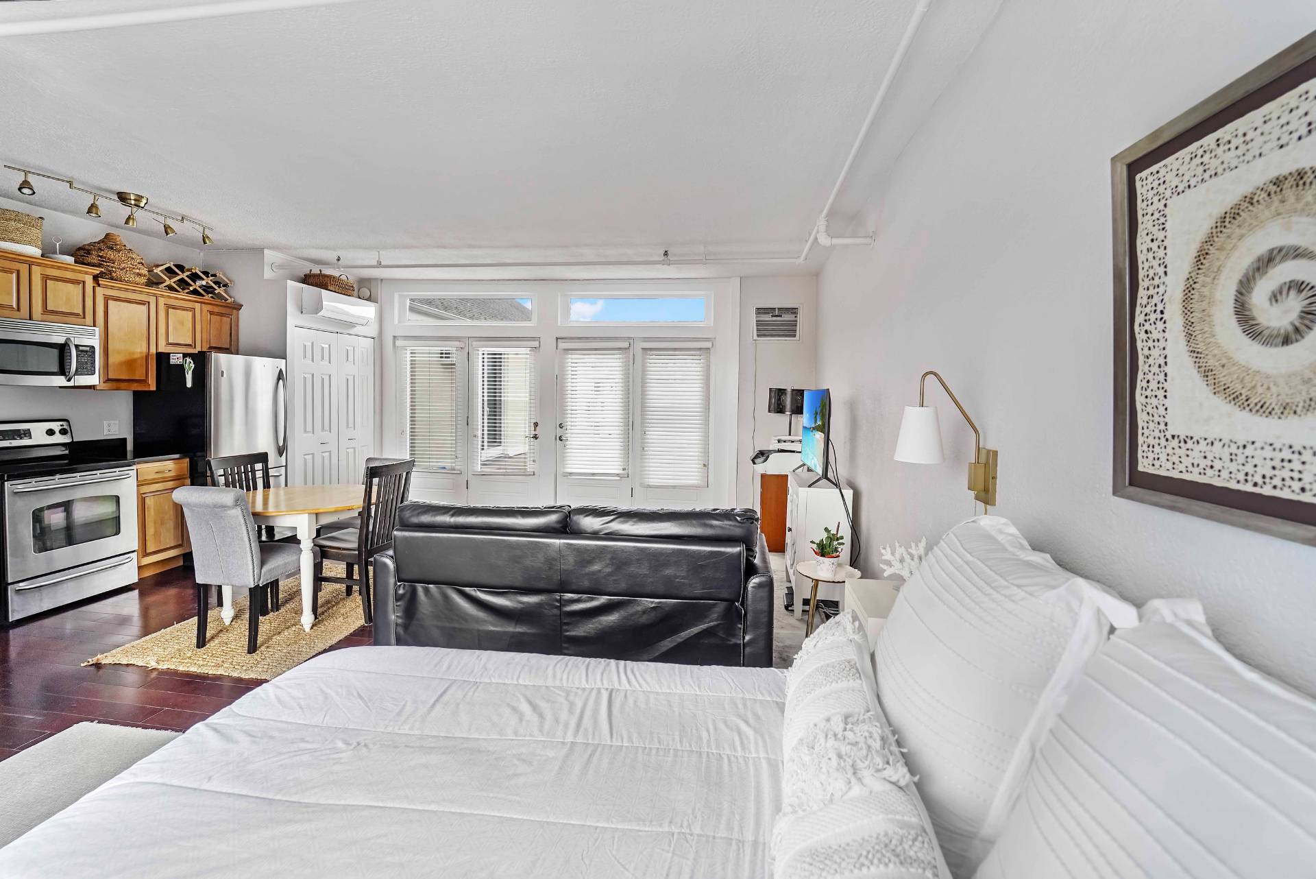 52 Main Street, Unit 1 Westhampton Beach, NY 11978 - Photo 10 of 13 a living room with furniture and a window