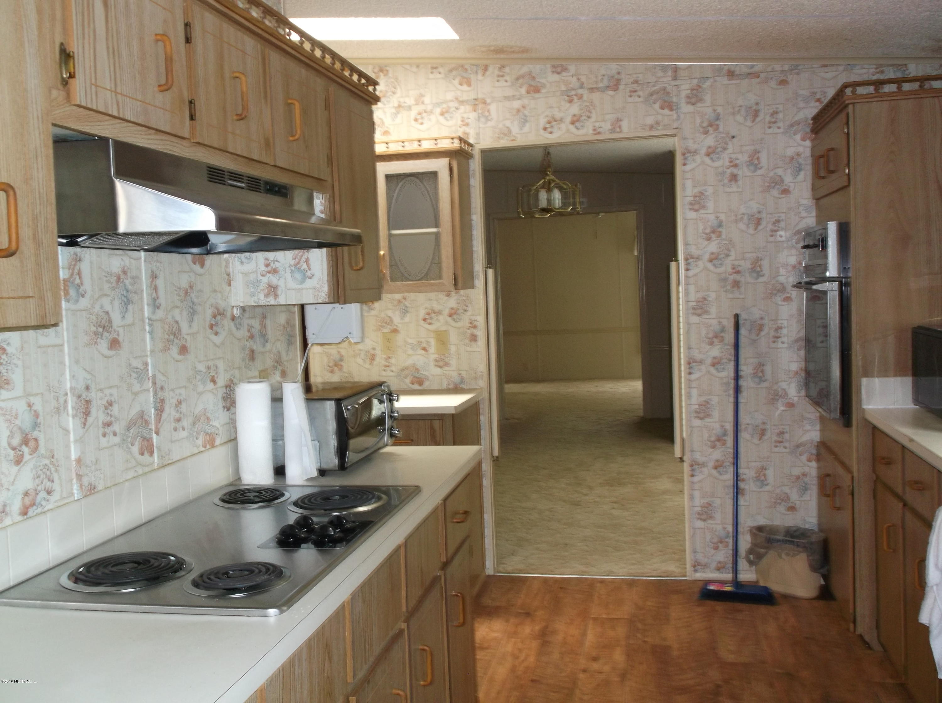 113 Keuka Road Interlachen, FL 32148 - Photo 4 of 31 kitchen to living room