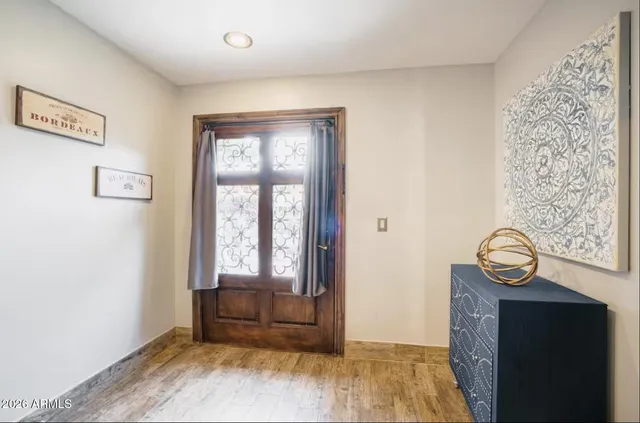 a view of an entryway with wooden floor