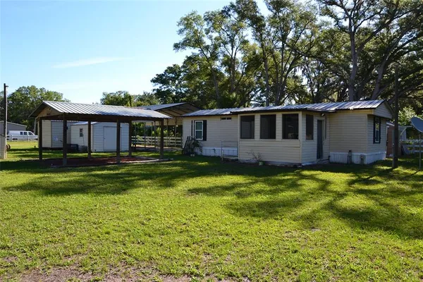 a front view of house with yard and green space