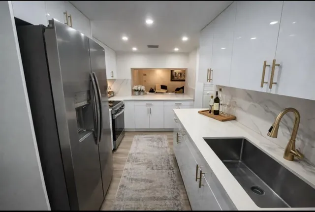 a kitchen with refrigerator and sink