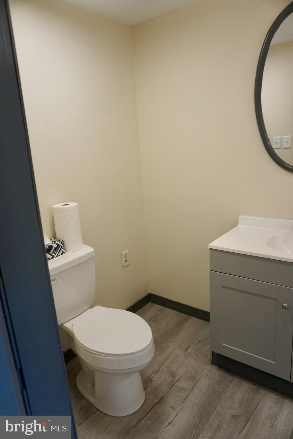 642 Stow Creek Road Bridgeton, NJ 08302 - Photo 13 of 25 a white toilet sitting next to a sink and vanity