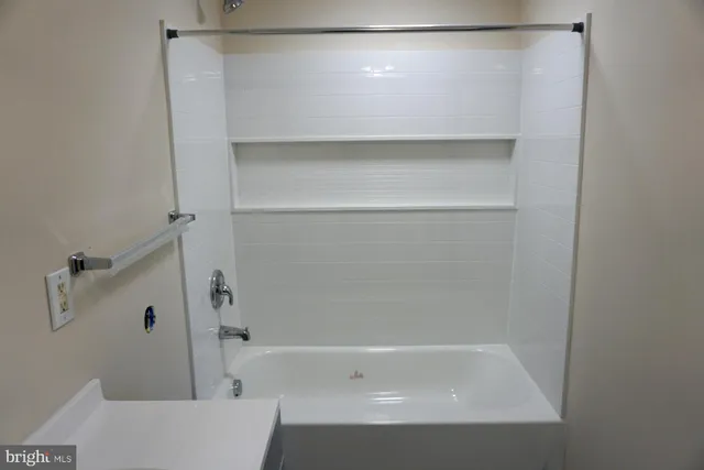 a white toilet sitting next to a sink and vanity