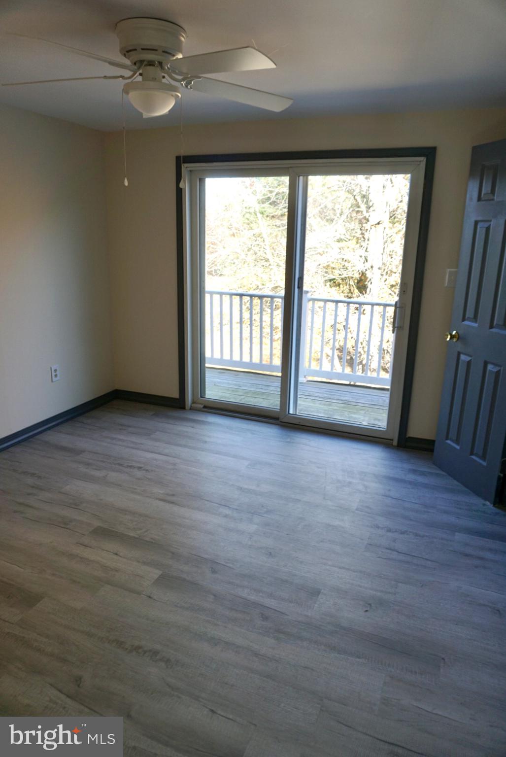 642 Stow Creek Road Bridgeton, NJ 08302 - Photo 15 of 25 a view of an empty room with wooden floor and a window