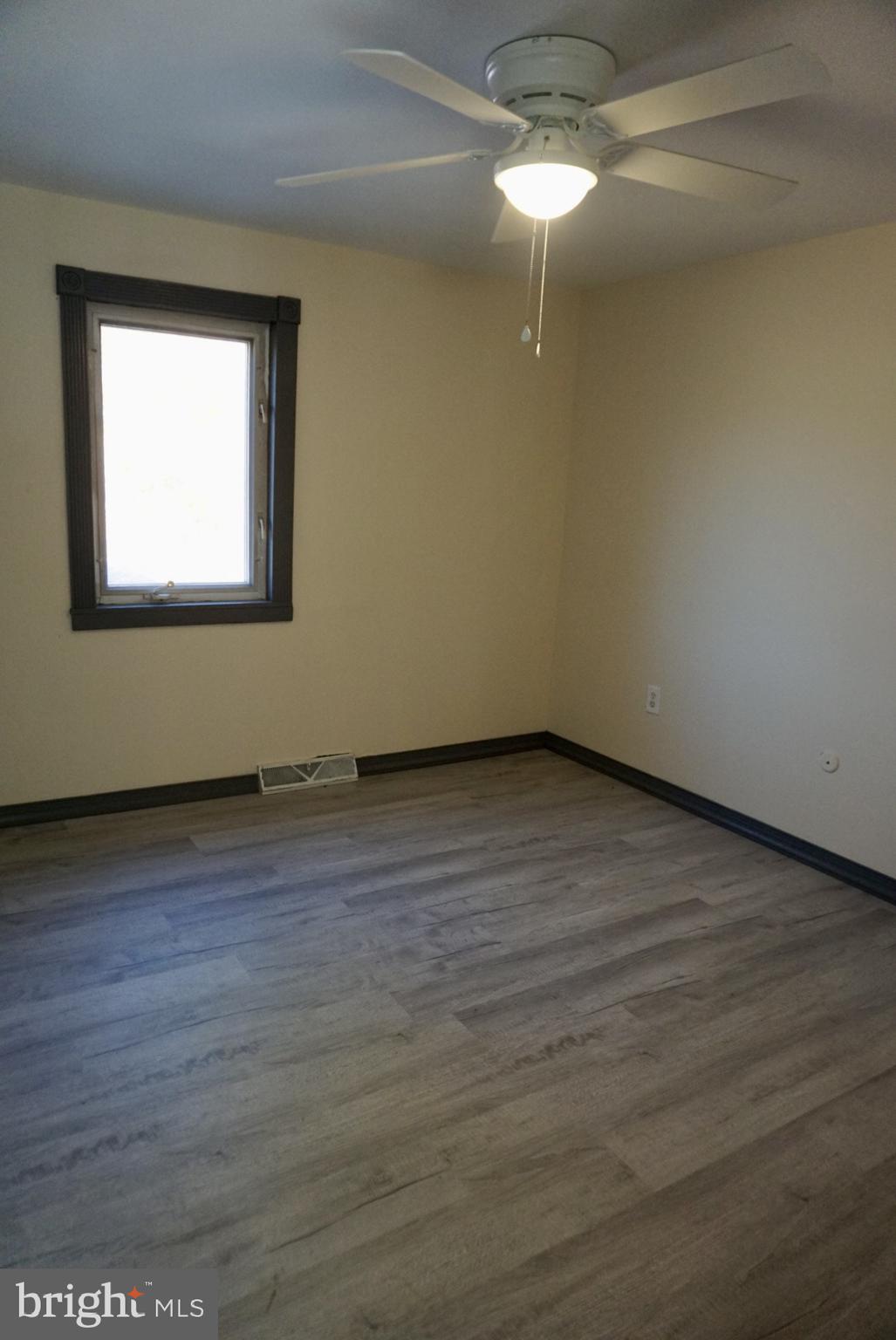 642 Stow Creek Road Bridgeton, NJ 08302 - Photo 18 of 25 a view of an empty room with wooden floor and a window