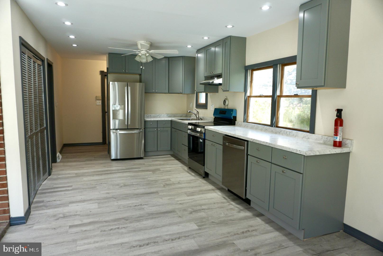 642 Stow Creek Road Bridgeton, NJ 08302 - Photo 2 of 25 a kitchen with stainless steel appliances granite countertop a sink stove and refrigerator
