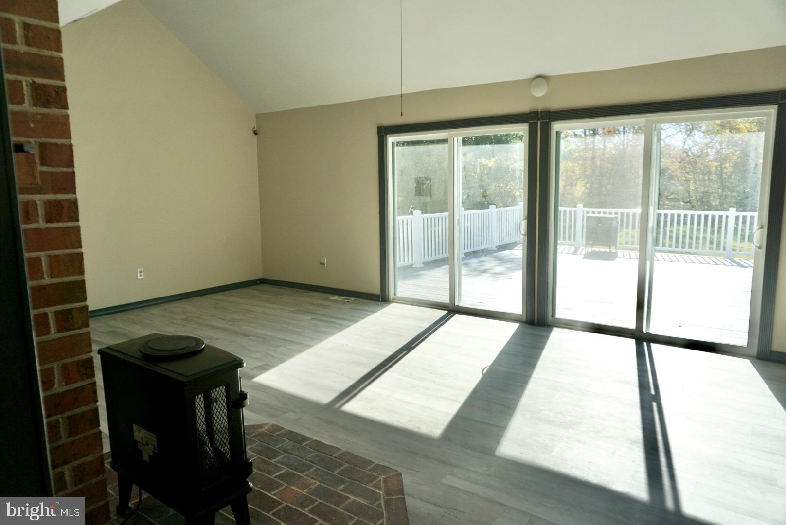 642 Stow Creek Road Bridgeton, NJ 08302 - Photo 5 of 25 a view of an empty room with wooden floor and windows