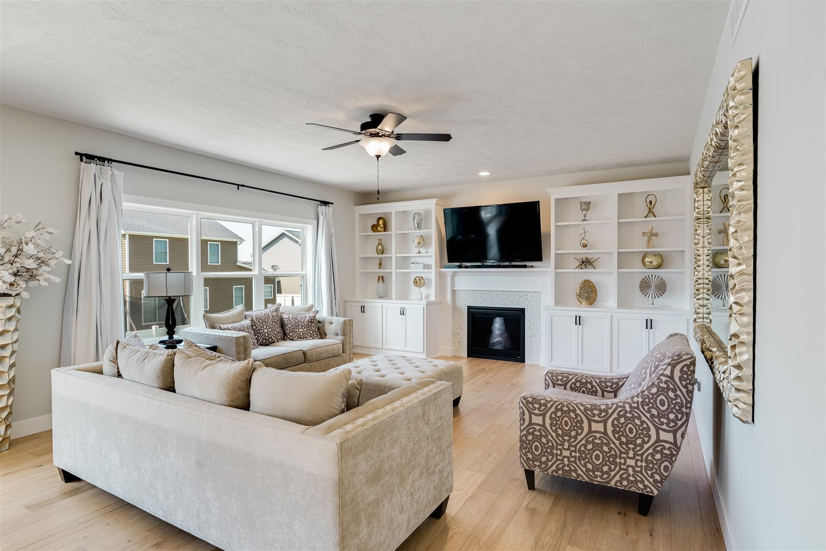 18 Red Maple Court Bloomington, IL 61705 - Photo 12 of 48 a living room with furniture a fireplace and a flat screen tv