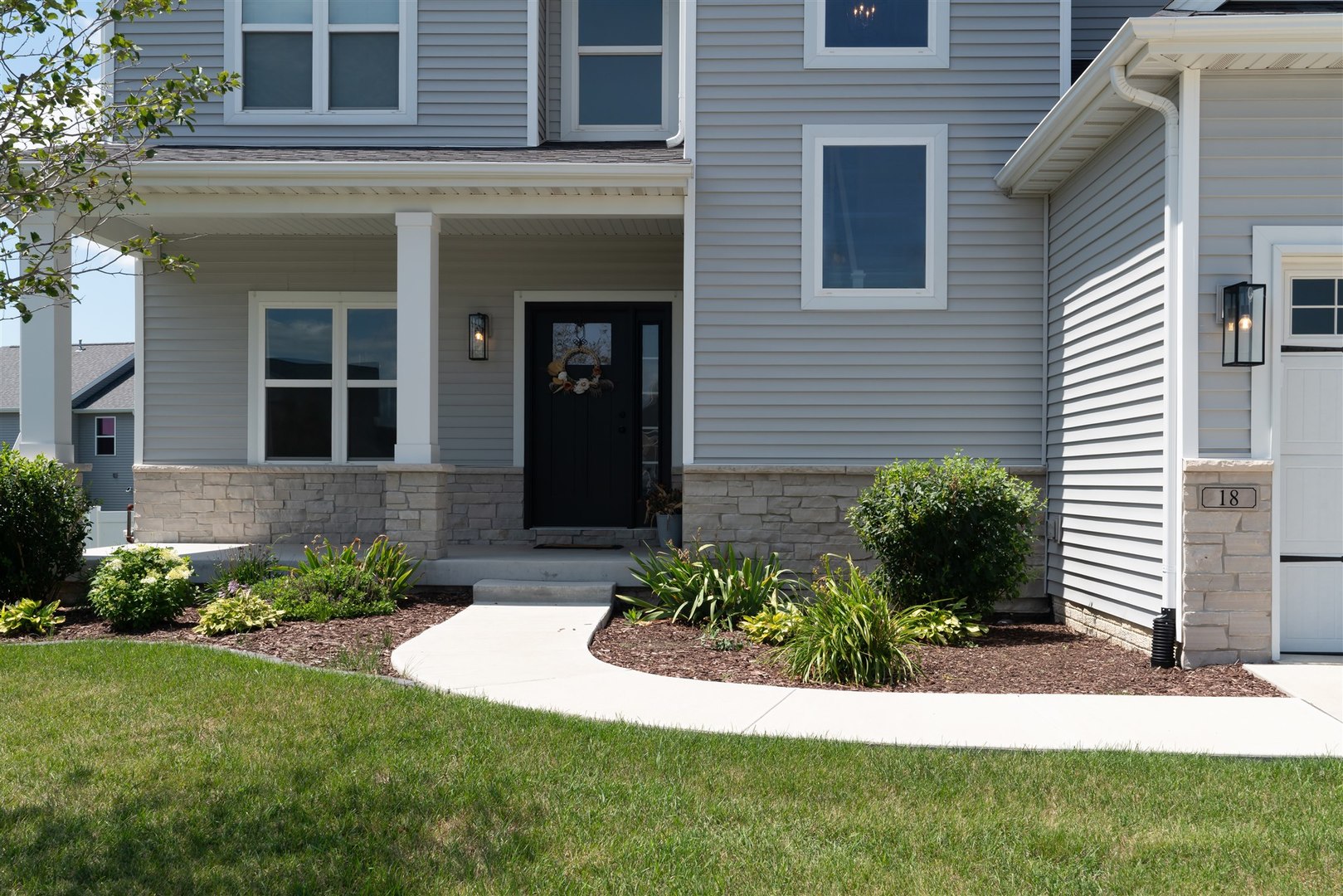 18 Red Maple Court Bloomington, IL 61705 - Photo 4 of 48 a view of a house with a garden and plants